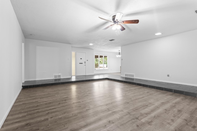 4635 30th St, Lubbock, TX 79410 - unfurnished living room with a ceiling fan, wood finished floors, and recessed lighting