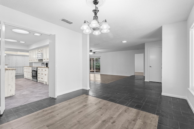 4635 30th St, Lubbock, TX 79410 - spare room featuring a chandelier, ceiling fan, dark wood-type flooring, and recessed lighting