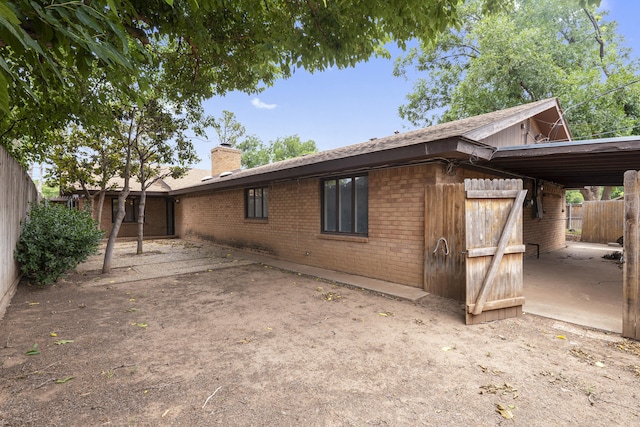 4635 30th St, Lubbock, TX 79410 - view of side of property featuring brick siding and a chimney