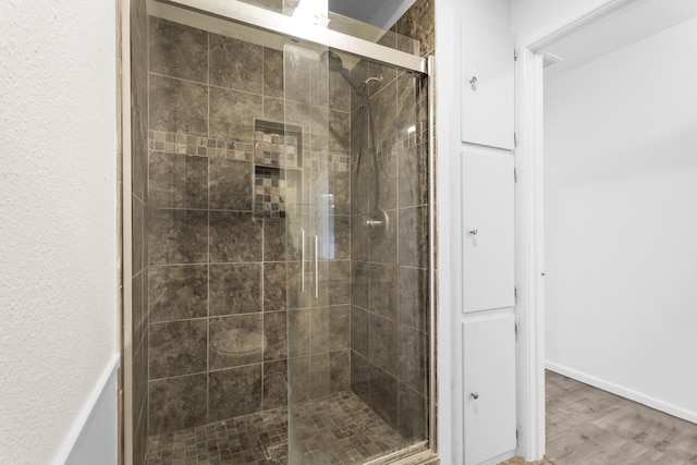 4635 30th St, Lubbock, TX 79410 - bathroom with a stall shower and wood finished floors