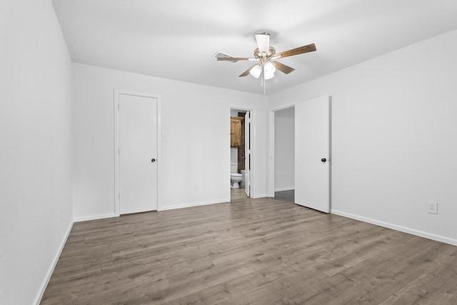 4635 30th St, Lubbock, TX 79410 - unfurnished bedroom with wood finished floors, ensuite bath, and a ceiling fan