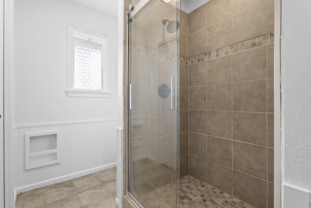 4635 30th St, Lubbock, TX 79410 - full bathroom featuring a stall shower, wainscoting, and a decorative wall