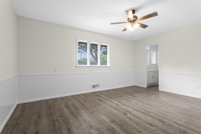 4635 30th St, Lubbock, TX 79410 - unfurnished room featuring wood finished floors, a wainscoted wall, and ceiling fan