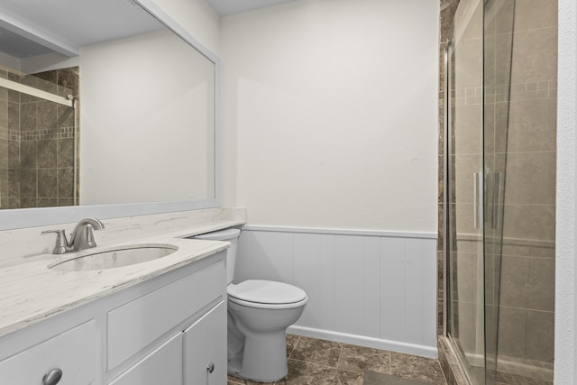 4635 30th St, Lubbock, TX 79410 - full bathroom with vanity, a stall shower, and a wainscoted wall