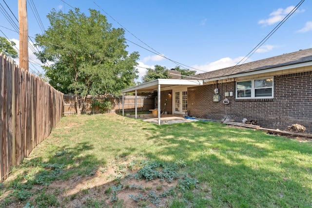 view of yard with a patio and french doors