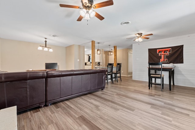 living room with ceiling fan and light wood-type flooring