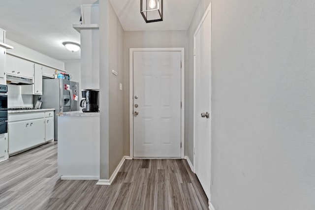 entryway with light hardwood / wood-style flooring