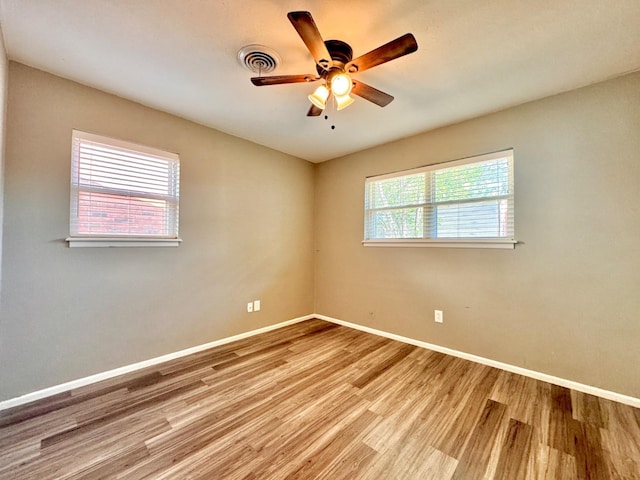 unfurnished room with ceiling fan and light wood-type flooring