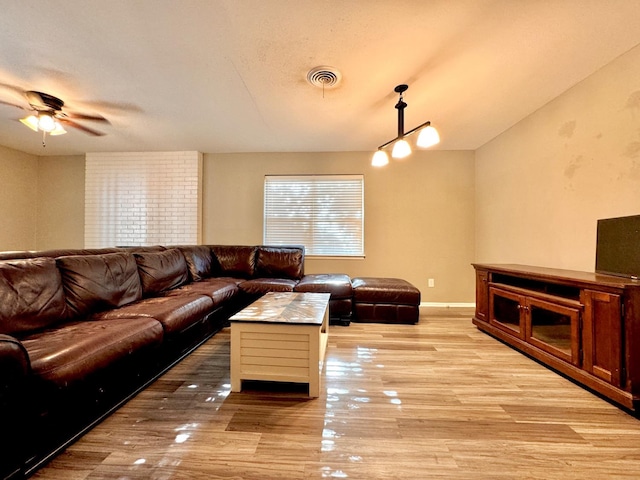 living room with a textured ceiling and light hardwood / wood-style floors