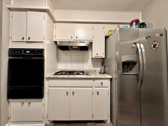 kitchen featuring backsplash, white cabinets, and appliances with stainless steel finishes