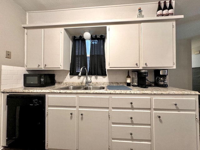 kitchen featuring decorative backsplash, sink, white cabinets, and black appliances