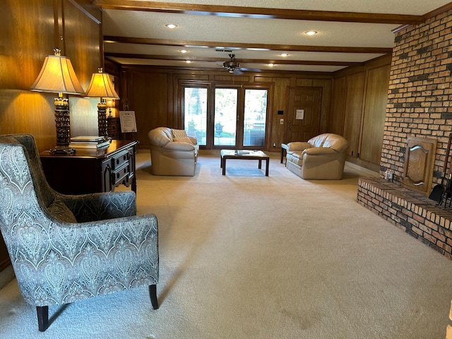 living room with beamed ceiling, wooden walls, and carpet flooring