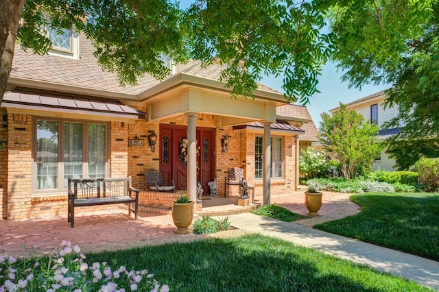 exterior space featuring a yard and covered porch