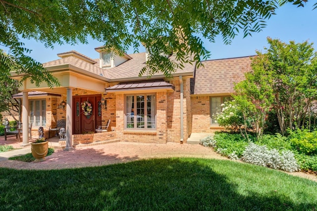 rear view of property with a lawn