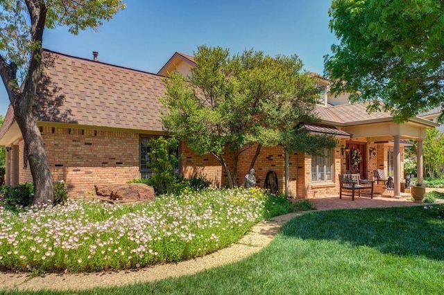 back of property with a patio area and a lawn