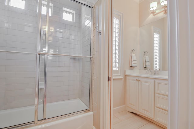 bathroom with vanity, tile patterned floors, and combined bath / shower with glass door