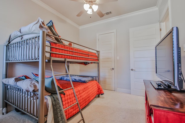 carpeted bedroom featuring ornamental molding and ceiling fan