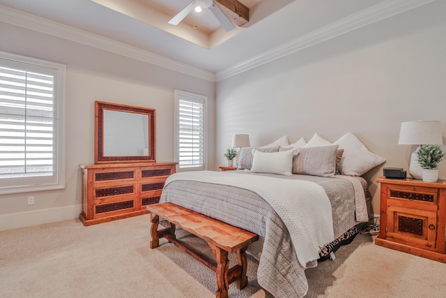 bedroom with multiple windows, crown molding, a raised ceiling, and light carpet