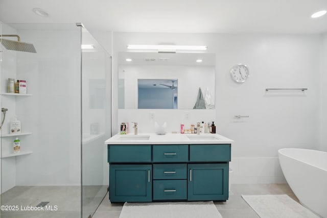 4509 76th St, Lubbock, TX 79424 - bathroom with walk in shower, double vanity, a soaking tub, tile patterned flooring, and recessed lighting