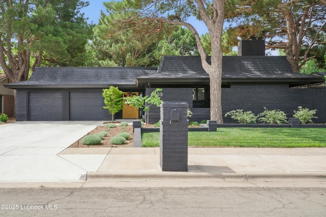 4509 76th St, Lubbock, TX 79424 - view of front facade featuring a garage, driveway, a chimney, and brick siding