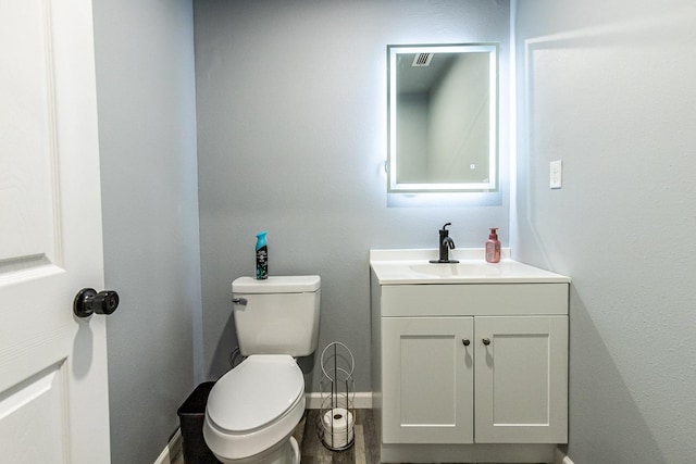 bathroom with vanity and toilet