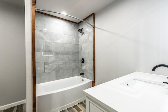 bathroom with vanity, hardwood / wood-style floors, and tiled shower / bath combo