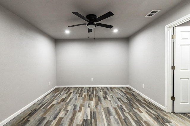 spare room featuring dark hardwood / wood-style floors and ceiling fan