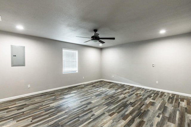 spare room with ceiling fan, dark hardwood / wood-style flooring, and electric panel