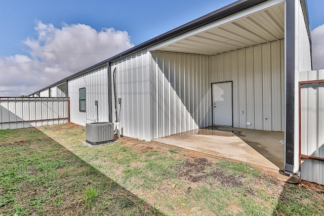 exterior space featuring cooling unit and a yard