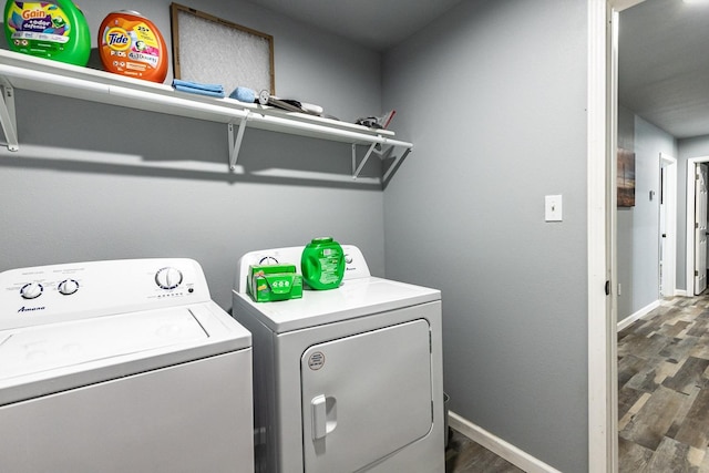 washroom with dark hardwood / wood-style floors and washing machine and clothes dryer