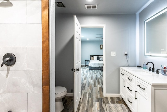 bathroom featuring hardwood / wood-style flooring, vanity, and toilet