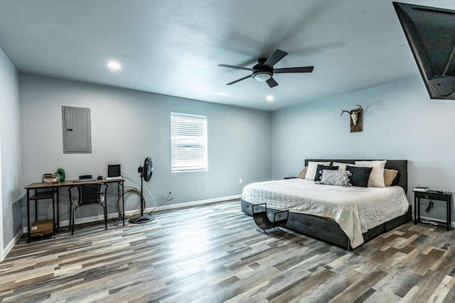 bedroom featuring hardwood / wood-style floors, electric panel, and ceiling fan