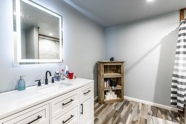 bathroom featuring hardwood / wood-style flooring, vanity, and a shower with curtain