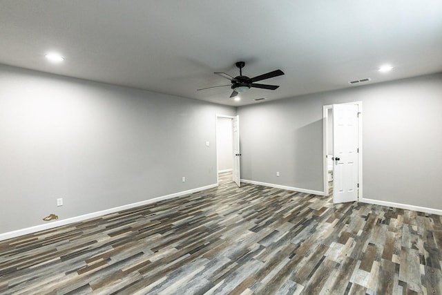 empty room featuring dark wood-type flooring and ceiling fan