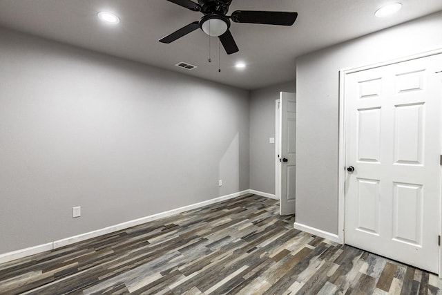 unfurnished room featuring dark hardwood / wood-style flooring and ceiling fan