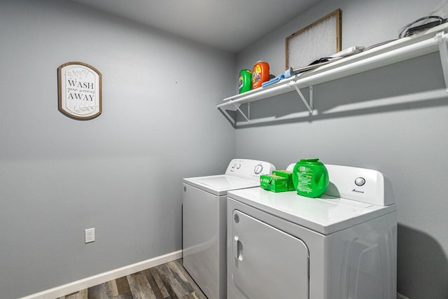 laundry area with washing machine and dryer and dark wood-type flooring