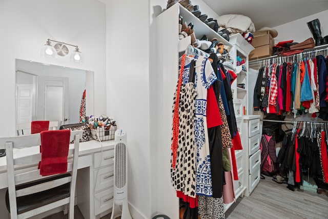 walk in closet with wood finished floors