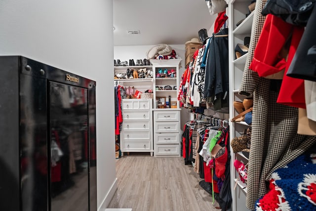 walk in closet featuring wood finished floors