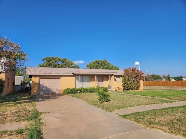 ranch-style house with a garage, driveway, a front yard, and fence