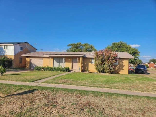 ranch-style home featuring a front lawn and an attached garage