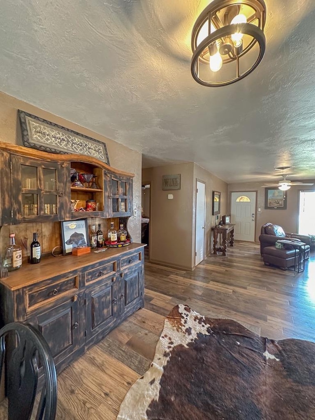 interior space featuring a textured ceiling and wood finished floors