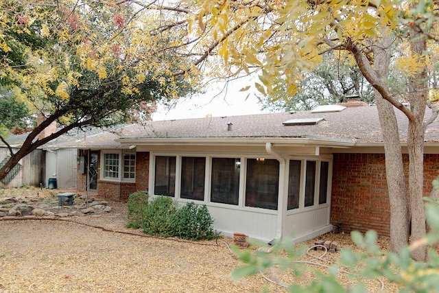 rear view of property with a sunroom