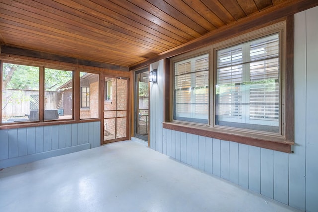 unfurnished sunroom featuring wood ceiling