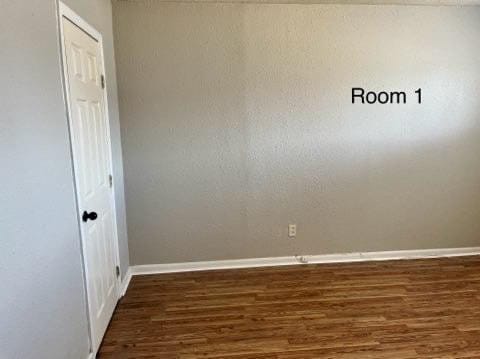 spare room with dark hardwood / wood-style flooring