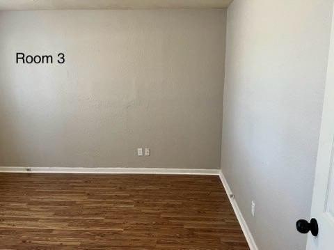 spare room with dark hardwood / wood-style flooring