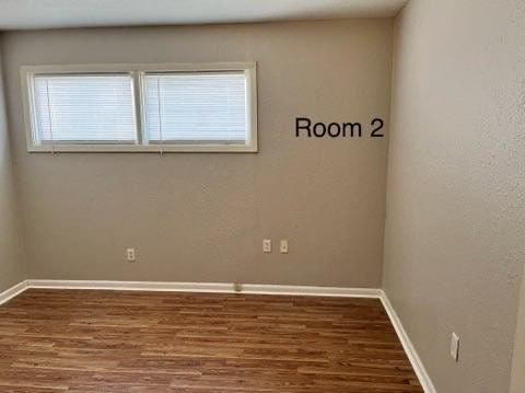 unfurnished room featuring dark hardwood / wood-style floors