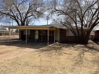 back of house with a carport