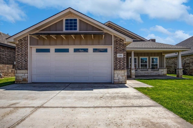 view of front of property with a garage and a front lawn