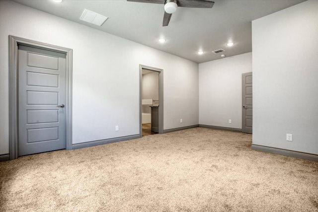 carpeted spare room with ceiling fan