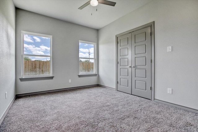 unfurnished bedroom featuring ceiling fan and carpet